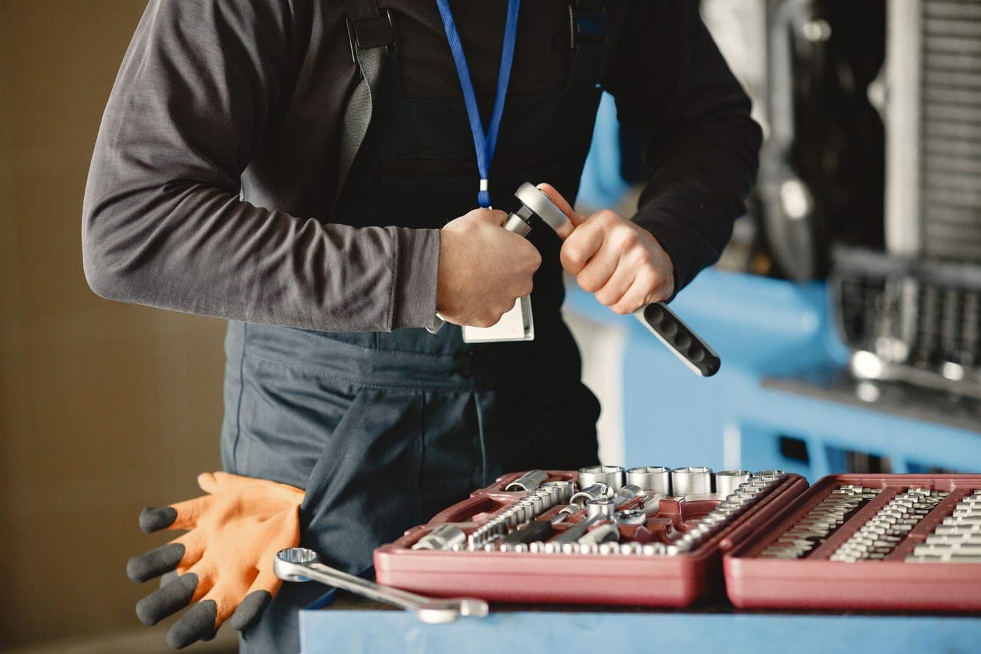 A mechanic preparing hand tools from a toolbox for vehicle repair