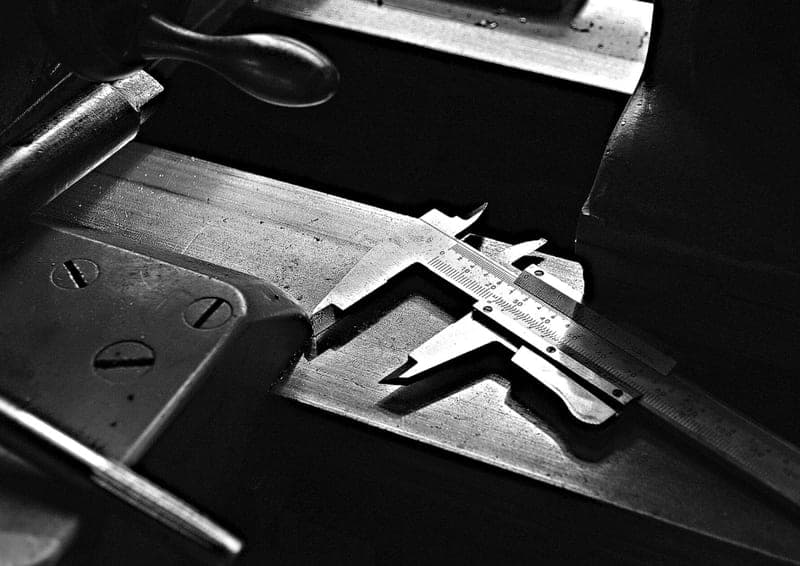 A precision caliper tool resting on a workshop table